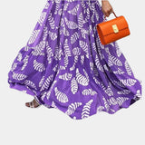 Vibrant purple leaf print maxi skirt with a boho high waist design, perfect for summer wear.