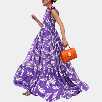 Purple leaf print maxi skirt featuring a boho high waist design, displayed in a size 2XL. The skirt's vibrant violet hue and flowing fabric evoke a summer feel, perfect for a chic and fashionable look.