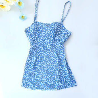 
A blue knee-length day dress featuring a vibrant floral print, adjustable straps, and a classic neckline, suitable for casual outings.