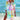 Woman wearing a vibrant tie-dye beach cover-up dress with rainbow shell pattern, standing near water, showcasing summer beachwear in size 5XL.