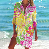 A vibrant tie-dye beach cover-up tunic dress in a colorful boho style, featuring yellow flower patterns in a 3XL size, with a mix of pink, aqua, and magenta hues. The dress includes a loose fit with a distinct neckline and sleeves, perfect for a beach outing.