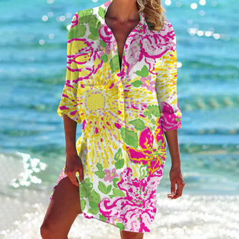 A vibrant tie-dye beach cover-up tunic dress in a colorful boho style, featuring yellow flower patterns in a 3XL size, with a mix of pink, aqua, and magenta hues. The dress includes a loose fit with a distinct neckline and sleeves, perfect for a beach outing.