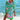 Woman wearing a vibrant tie-dye beach cover-up dress in pink island color, standing near water, showcasing the loose fit and colorful design, perfect for summer beachwear.