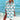 Woman wearing a vibrant tie-dye beach cover-up dress in mint green with anchor design, standing by the water.