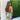 Vibrant watercolor sheer off-shoulder maxi evening dress in shades of magenta and electric blue with a flowing design, modeled by a person with long hair, standing outdoors on grass, evoking a summery and fashionable look.