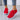 Vibrant women's lightweight neon running shoes in red, size 40, displayed on a standing model. The shoes feature breathable textile material with white and orange accents, offering a fashionable look.
