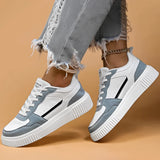 Vintage blue suede high sole sneakers for women, showcasing a retro fashion design. The sneakers are styled with grey accents and are ideal for walking or as a fashionable sportswear option. The image highlights the footwear against a neutral background.