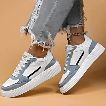 Vintage blue suede high sole sneakers for women, showcasing a retro fashion design. The sneakers are styled with grey accents and are ideal for walking or as a fashionable sportswear option. The image highlights the footwear against a neutral background.