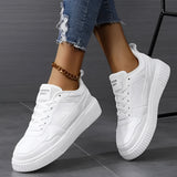 Vintage blue suede high sole sneakers for women, styled with white accents. The sneakers are showcased against a casual backdrop, complementing denim jeans and a hand slightly touching the shoes to highlight their retro fashion appeal.