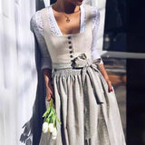 A vintage bohemian spring outfit featuring a gray lace cardigan, a knit top, and a pleated floral skirt, modeled on a mannequin. The outfit showcases intricate lace detailing on the cardigan, a comfortable knit top, and a flowy, pleated skirt with floral patterns, perfect for a casual, stylish look.
