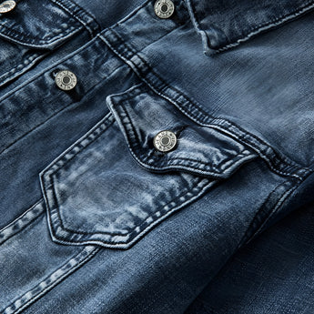 Vintage men's dark wash distressed denim jacket in classic trucker style, displayed on a white background with visible distressed detailing and high-quality denim material.