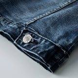 Vintage men's dark wash distressed denim jacket in classic trucker style, featuring long sleeves, visible stitching, and an electric blue tint.