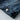 Vintage men's dark wash distressed denim jacket in classic trucker style, featuring long sleeves, visible stitching, and an electric blue tint.