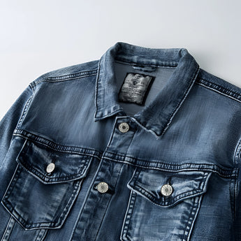 Vintage men's dark wash distressed denim jacket in classic trucker style with buttons, collar, sleeves, and front pockets.