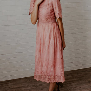 Vintage pink lace A-line summer wedding guest dress with intricate detailing, showcasing short sleeves and a modest neckline.