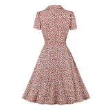 Vintage polka dot women's floral print A-line midi dress with short sleeves and a round neck, featuring a peach-colored floral pattern.
