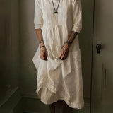Vintage white linen dress with bohemian loose fit, showcasing lightweight summer fabric in beige color. The dress features short sleeves, a collar, and falls around the knee. The model is wearing a size 5XL, highlighting the comfortable and airy design suitable for summer.