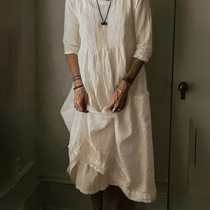 Vintage white linen dress with bohemian loose fit, showcasing lightweight summer fabric in beige color. The dress features short sleeves, a collar, and falls around the knee. The model is wearing a size 5XL, highlighting the comfortable and airy design suitable for summer.