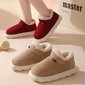 Warm fleece-lined winter slippers for women featuring a plush collar, in shades of pink and white, designed for comfort and style.