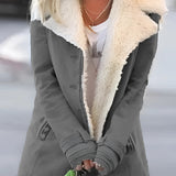 Warm women's gray winter jacket with sherpa lining, featuring a fashionable design with a collar, full sleeves, and tailored joints for enhanced thermal insulation.