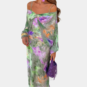 Elegant pastel green watercolor floral silk maxi dress in a one-piece design with a flowing, ankle-length silhouette. The dress features a rounded neckline, long sleeves, and a fitted waist, perfect for spring and summer occasions.
