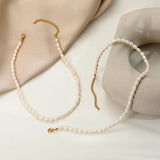 Waterproof hypoallergenic pearl choker necklace with silver chain, showcasing elegant beach jewelry design.