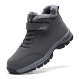 Waterproof grey insulated winter hiking boots with fur lining, designed for outdoor activities and walking.