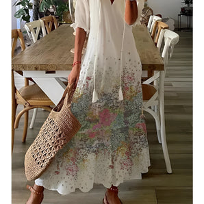 White Bohemian floral maxi dress featuring a lightweight fabric with a flowering meadow print, designed for summer casual wear, shown in size 3XL. The dress has short sleeves and a fitted waist, paired with sandals.