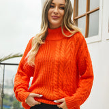 
A woman smiling and wearing a white cable knit turtleneck sweater, showcasing its cozy, fashionable design. The sweater features a high collar, long sleeves, and a textured knit pattern, suitable for winter wear. She is positioned near a window, which enhances the warm, inviting look of the outfit.