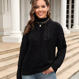 
Woman wearing a black cable knit turtleneck sweater paired with jeans, showcasing cozy winter fashion.