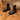 White chunky platform ankle boots for women with a zipper, displayed on a wooden floor.