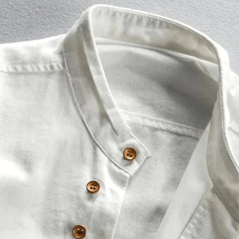 White cotton crew neck shirt with a lightweight and breathable fabric, featuring wooden buttons and a simple design.