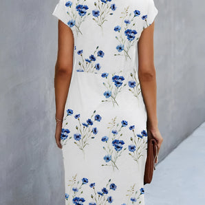 White floral dress with blue cornflower print, short sleeves, knee-length, and a round neck.