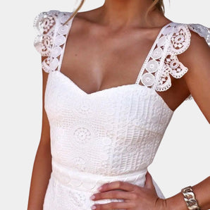 White floral lace dress with V-neck and bohemian style, showcasing delicate shoulder and arm design, fitted waist, and short sleeves.