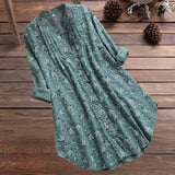 
A woman wearing a white floral long sleeve tunic dress designed for summer, in a green color and size XL. The dress features lightweight fabric, suitable for daytime wear.