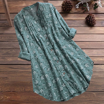 
A woman wearing a white floral long sleeve tunic dress designed for summer, in a green color and size XL. The dress features lightweight fabric, suitable for daytime wear.