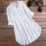 White floral long sleeve tunic dress on a clothes hanger, featuring a lightweight fabric with an intricate floral pattern, displayed against a light background.