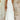 White halterneck tiered midi dress modeled by a fashion model, showcasing the elegant summer resort wear with a focus on the halterneck design, sleeveless style, and fitted waist in a 4XL size.