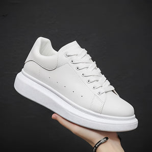 White leather low-top sneakers designed for minimalist comfort, featuring a sleek unisex design ideal for walking and sportswear activities.
