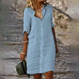 White linen button-down dress in Azzurro color, featuring short sleeves, a collar, and knee-length design, suitable as a casual summer beach cover-up.