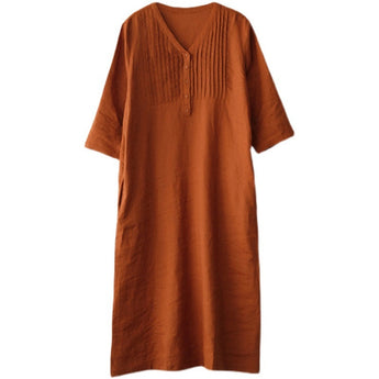 White linen midi dress with a V-neckline, pleated design, and long sleeves, showcasing sustainable fashion.