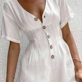 A woman wearing a white linen mini dress with short sleeves, a collar, and a lightweight, breathable fabric ideal for summer.