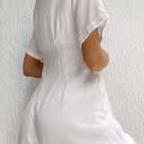 White linen mini dress with short sleeves, a fitted waist, and a lightweight, breathable fabric ideal for summer.