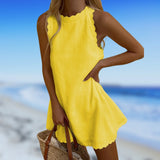 Yellow sleeveless dress with a ruffled neckline, designed for a lightweight and comfortable beachwear experience, displayed against a natural outdoor background.