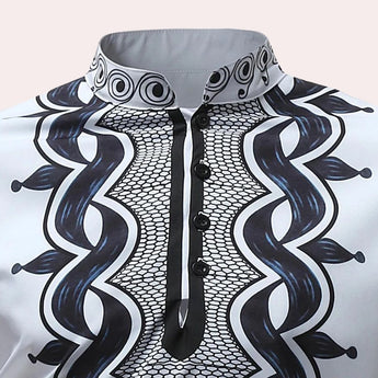 White long-sleeve men's shirt featuring embroidered cuffs and a patterned collar, styled for formal wear with symmetrical design elements.