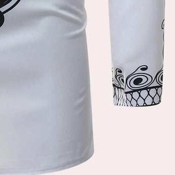White long-sleeve men's shirt with embroidered cuffs and a patterned collar, displayed on a neutral background, highlighting the intricate detailing on the cuffs and collar.