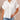 White loose fit women's summer linen shirt with short sleeves, designed for a casual look. The shirt features a classic collar and is made from lightweight linen material, perfect for warm weather.