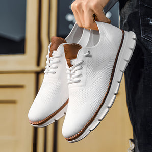 White mesh sneakers featuring a lightweight and breathable design, accented with brown details, perfect for walking and outdoor activities.
