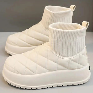 White quilted insulated lightweight winter snow boots with a beige shade, designed for comfort and outdoor walking, featuring a synthetic rubber sole.