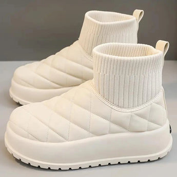 White quilted insulated lightweight winter snow boots with a beige shade, designed for comfort and outdoor walking, featuring a synthetic rubber sole.